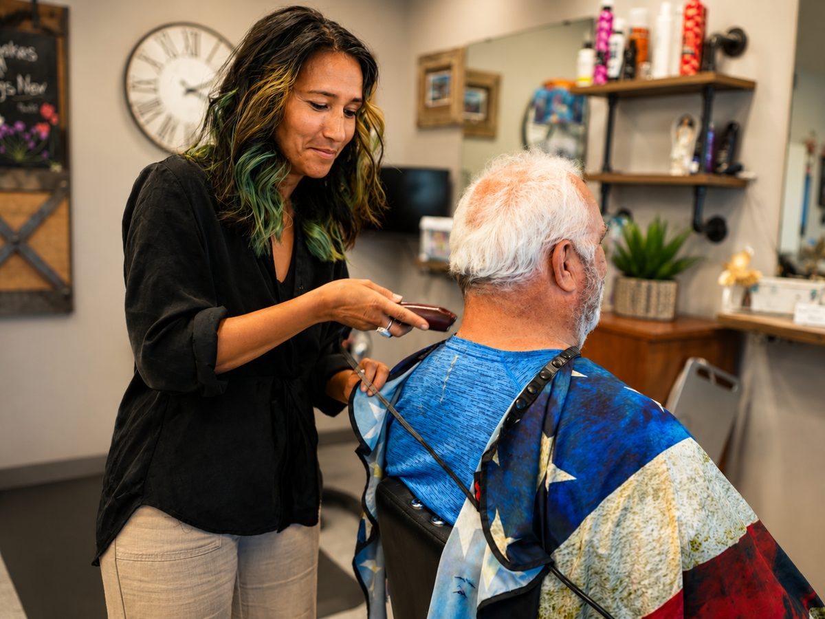 A TeamClips stylist cutting a client's hair